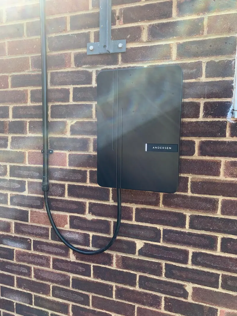 Charcoal Andersen EV charger on engineering brick, its supply in conduit from above