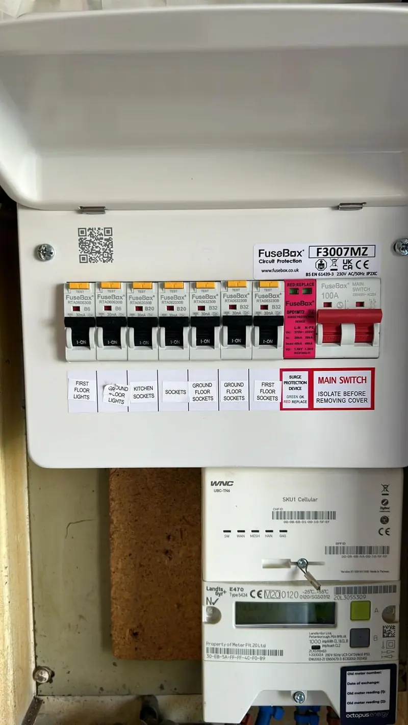New FuseBox consumer unit with RCBOs and a surge protection device, fitted above the electricity meter, circuits labelled