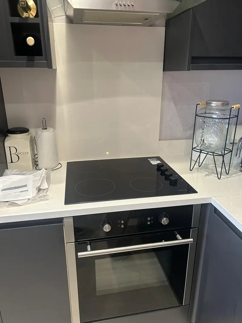 The same ceramic hob installed in a grey kitchen with the oven below