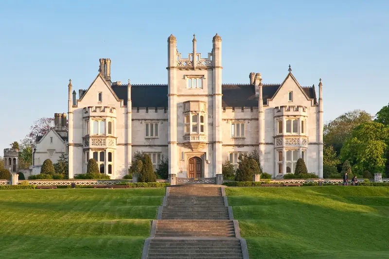 Ingress Abbey in Greenhithe: a pale stone Gothic house with a central tower above wide lawns and a flight of steps